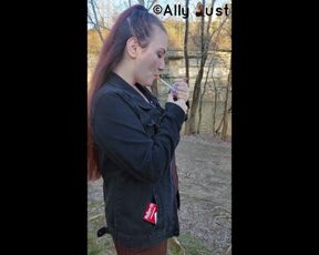 Opening a new pack and smoking by the water in a dress and jean jacket