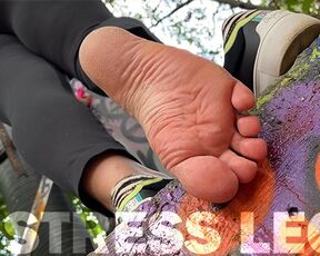 Pink socks and natural rough wrinkled soles above you outdoor